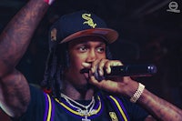 a man with tattoos holding a microphone