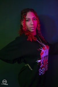 a woman with red hair posing for a photo