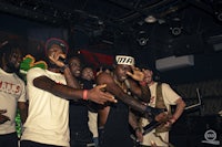 a group of people standing in front of a stage