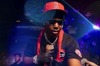 a man in a red hat is holding a microphone