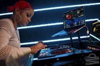 a woman djing on a laptop