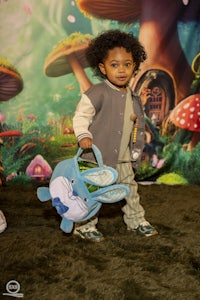 a child holding a stuffed animal