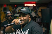 a man is holding a microphone in front of a group of people