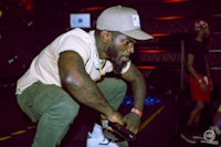 a man crouching down in front of a crowd