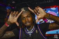 a man with tattoos making a sign with his hands