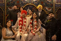 an indian wedding party posing for a photo