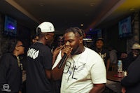 a man is singing in front of a crowd of people