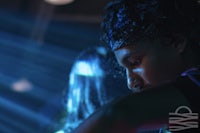 a man with a headband and a blue light in front of him