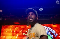 a man in a hat standing in front of a stage