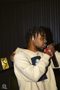 a man is holding a microphone while another man is holding a microphone