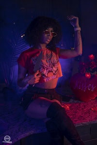 a woman wearing a t-shirt and a pair of thigh high boots